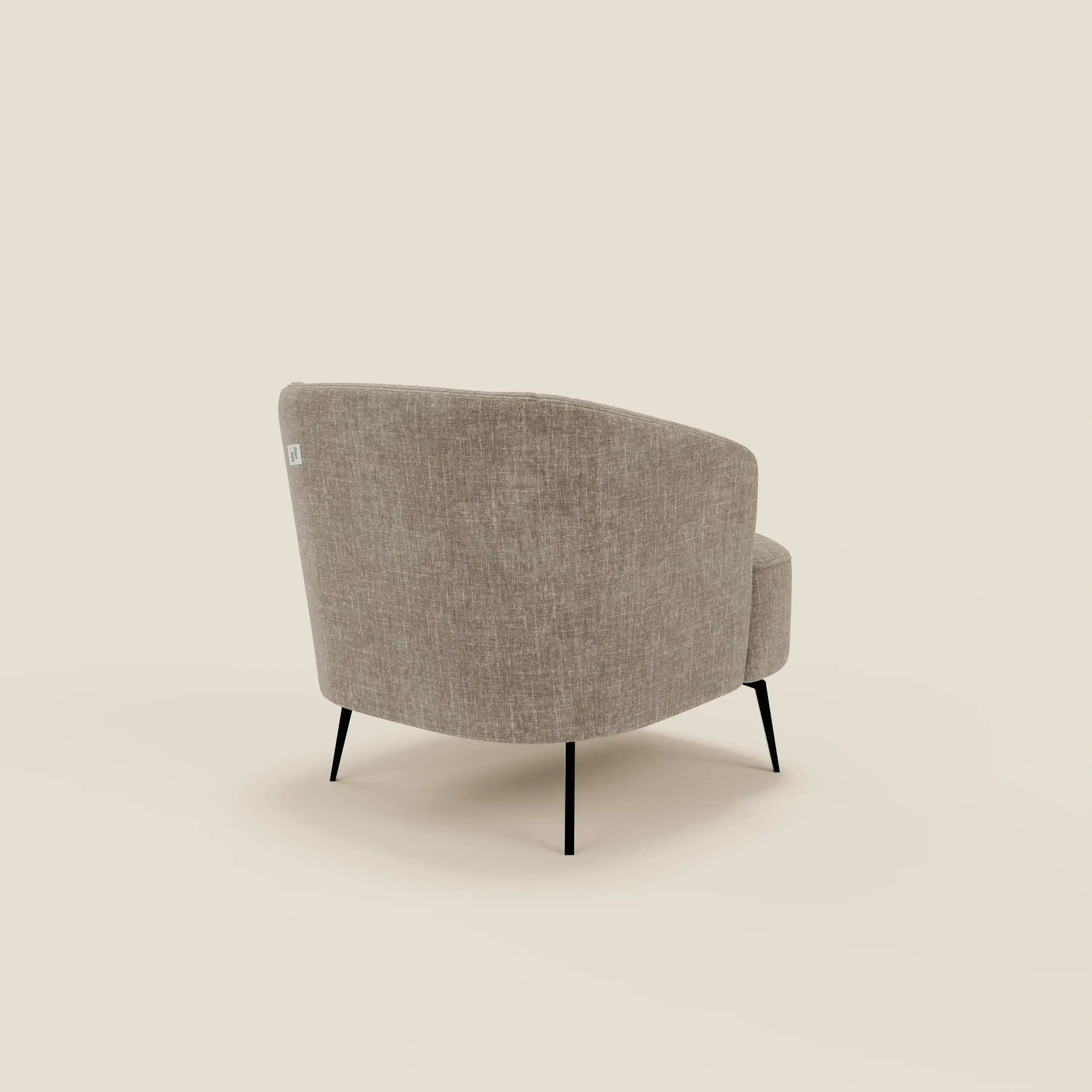La poltroncina Renoa dall'eleganza moderna di Divani.Store è rivestita in tessuto smacchiabile T24 marrone tortora, con schienale curvo e sottili gambe nere, ideale come poltroncina da salotto su sfondo beige chiaro.