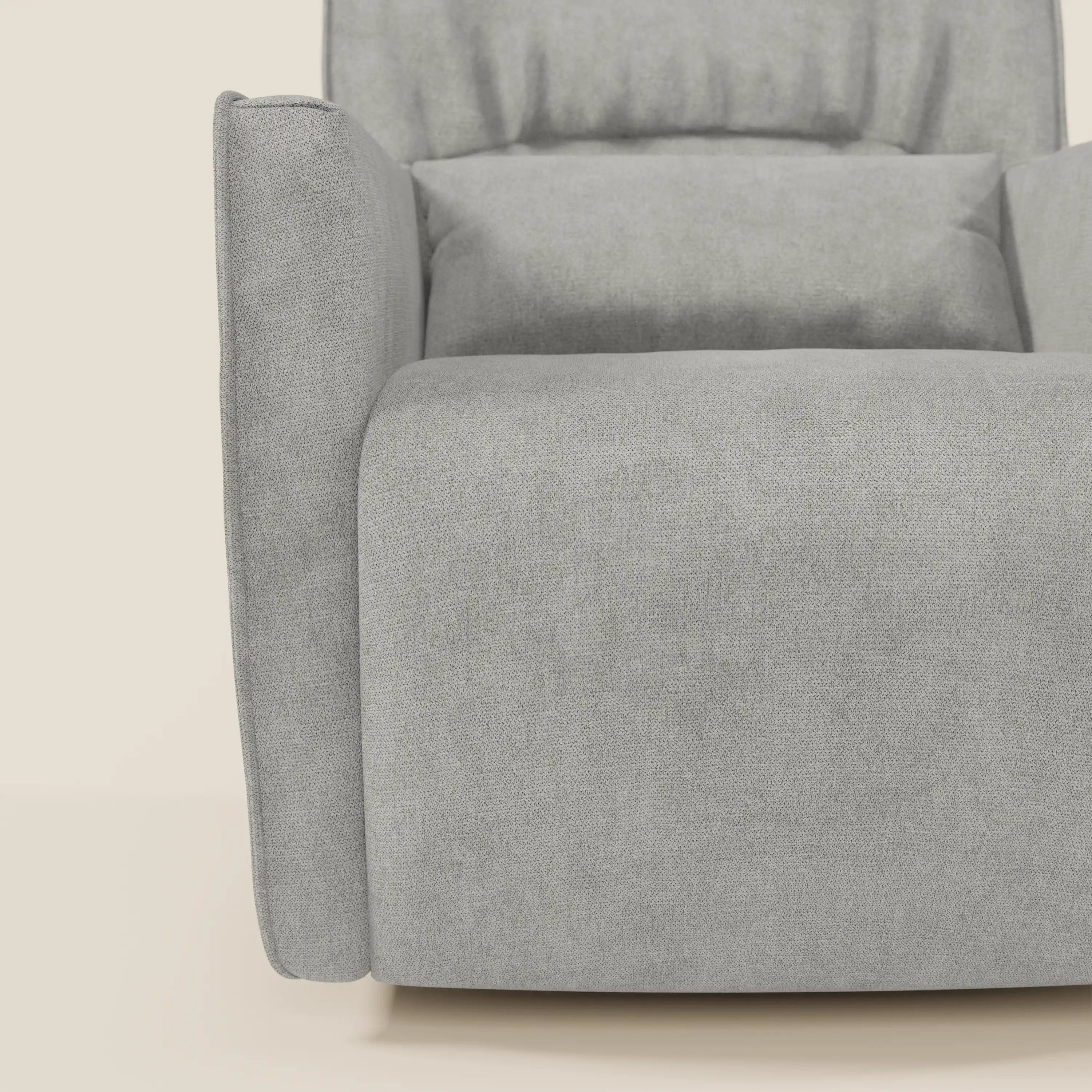 Primo piano di Tulla Poltrona girevole in tessuto impermeabile T02 grigio chiaro di Divani.Store, che mostra il bracciolo e la seduta dalle linee pulite, l'imbottitura spessa e la texture liscia su uno sfondo beige chiaro.