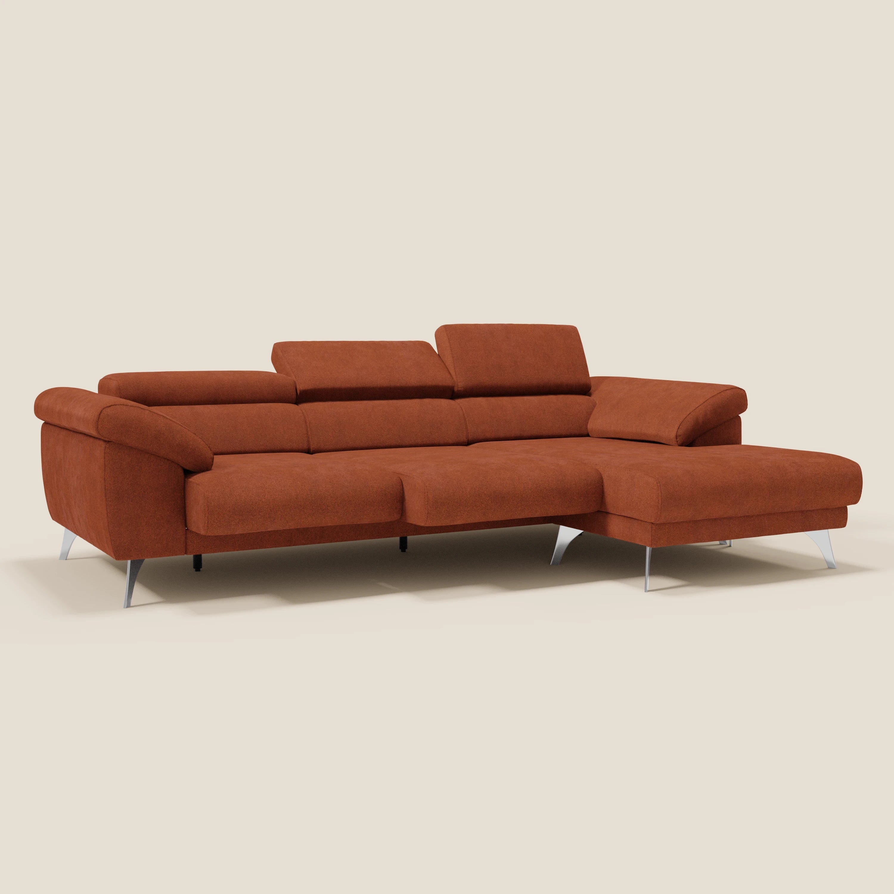 Il Donatello Divano angolare di Divani.Store è caratterizzato da sedute scorrevoli, braccioli contenitore e poggiatesta regolabili in morbido tessuto arancione ruggine T23 antimacchia, con chaise longue orientata verso destra ed eleganti gambe in metallo argentato.