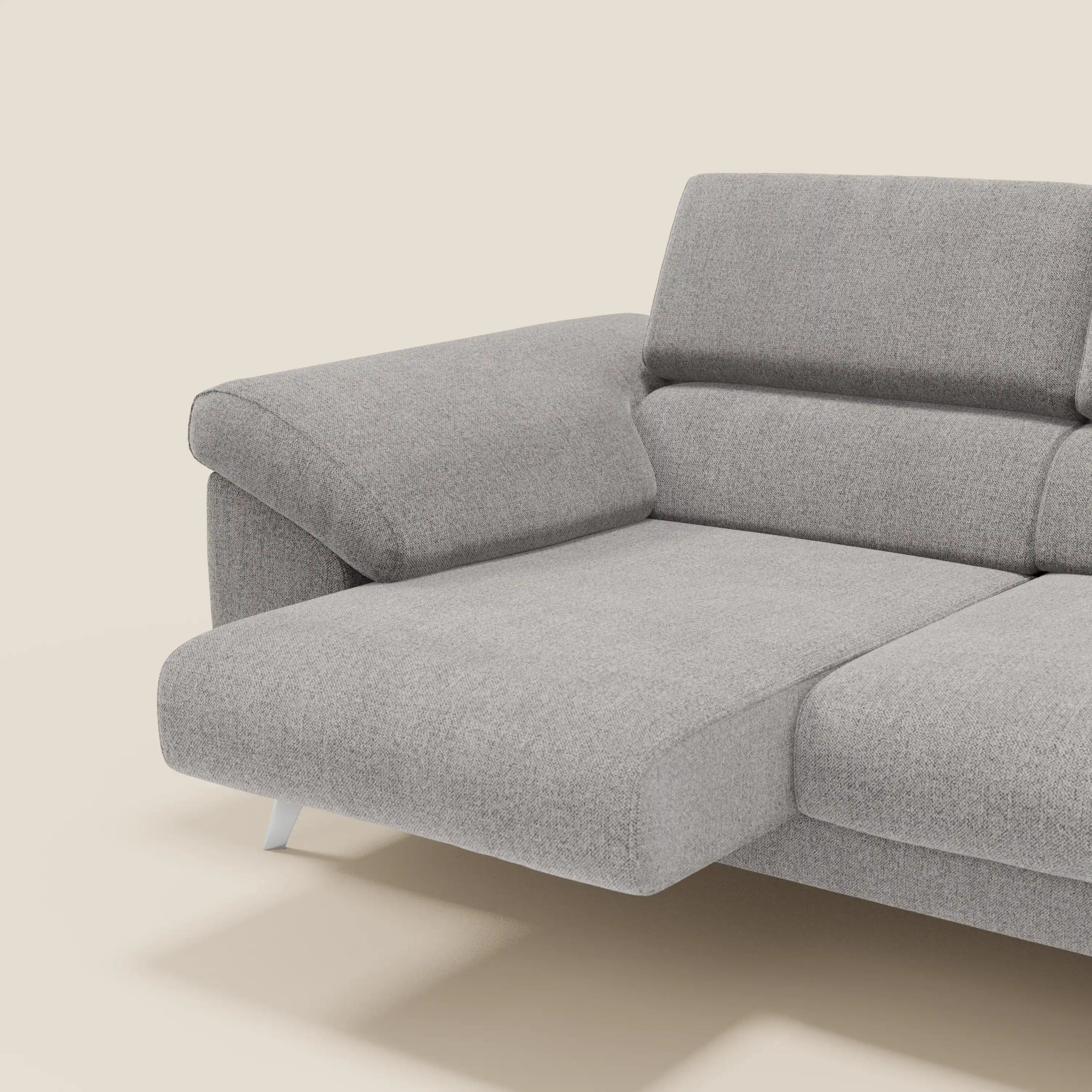 Il divano Donatello di Divani.Store è caratterizzato da 3 sedute estensibili, braccioli portaoggetti e poggiatesta regolabili in tessuto grigio T23 facile da pulire, ideale per un comfort personalizzabile su un morbido sfondo beige.